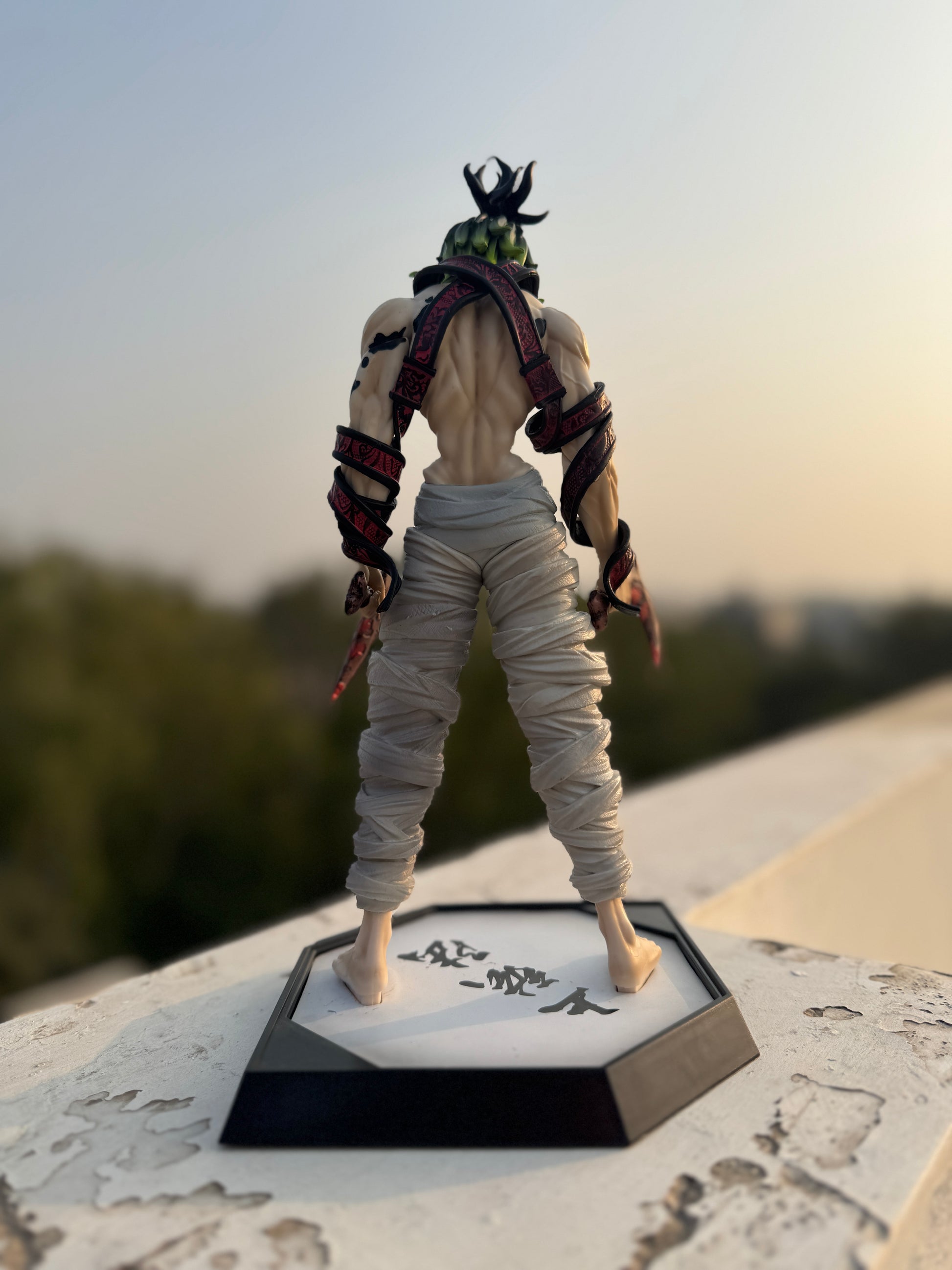 Action figure on a stand with a scenic background