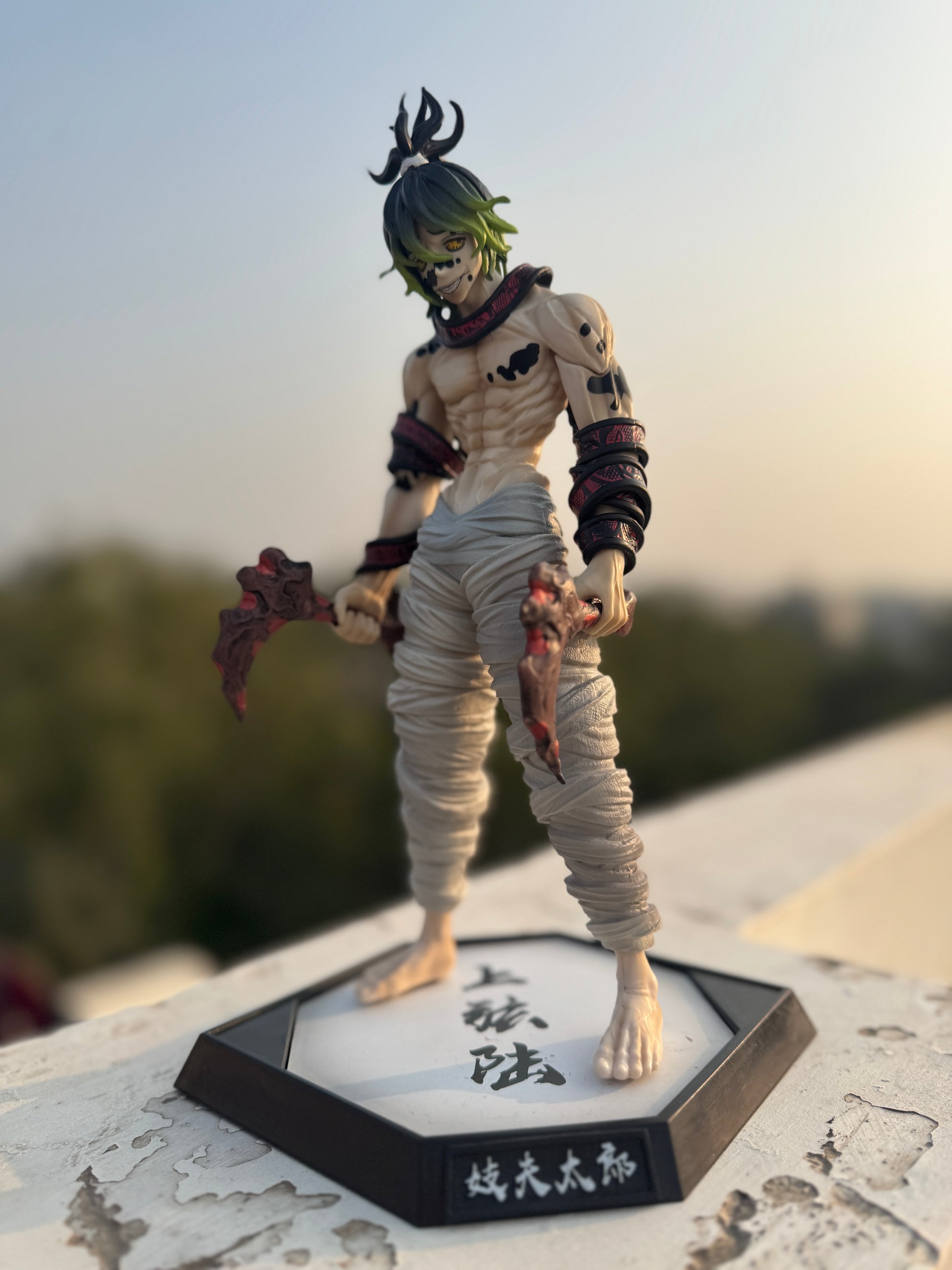Action figure on a stand with a blurred outdoor background