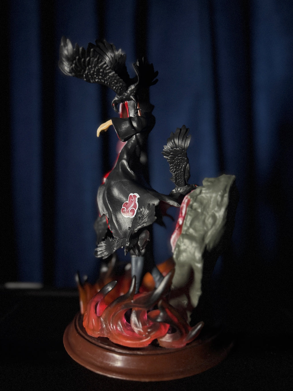 figurine of itachi with a dark background