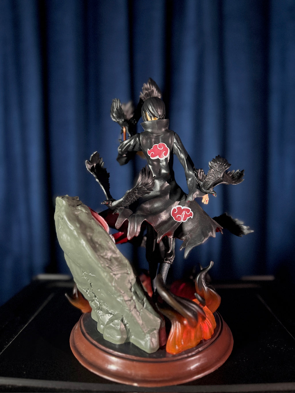 itachi figure with red cloud symbols on a dark background